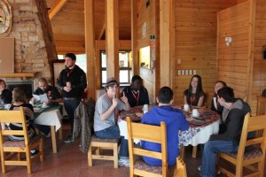 Group of YMCA Academy students and their exchange twins eating in the lodge at Oujé-Bougoumou, Quebec