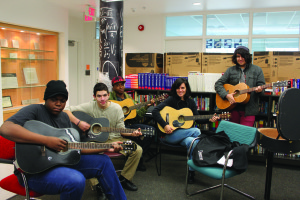 YMCA Academy students and teacher participate in Guitar Club