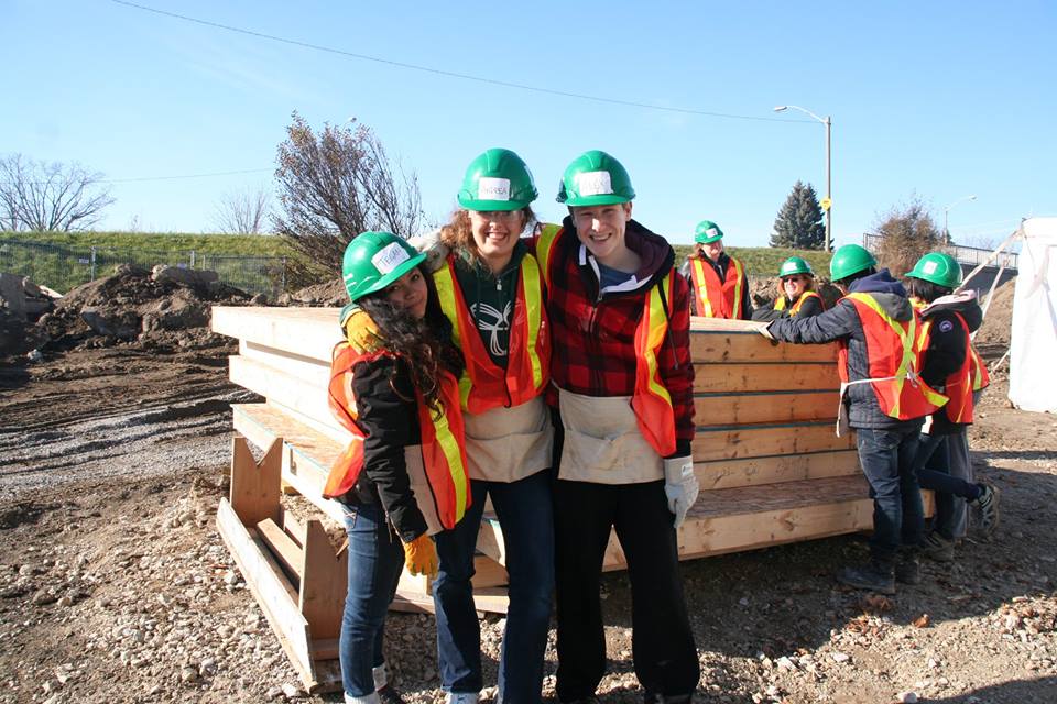 YMCA Academy students volunteering at a build site for Habitat for Humanity Holiday Campaign.