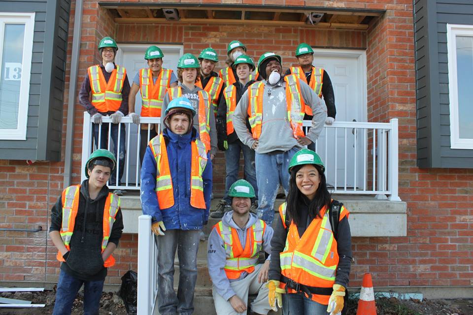YMCA Academy students volunteering at a build site for Habitat for Humanity Holiday Campaign.