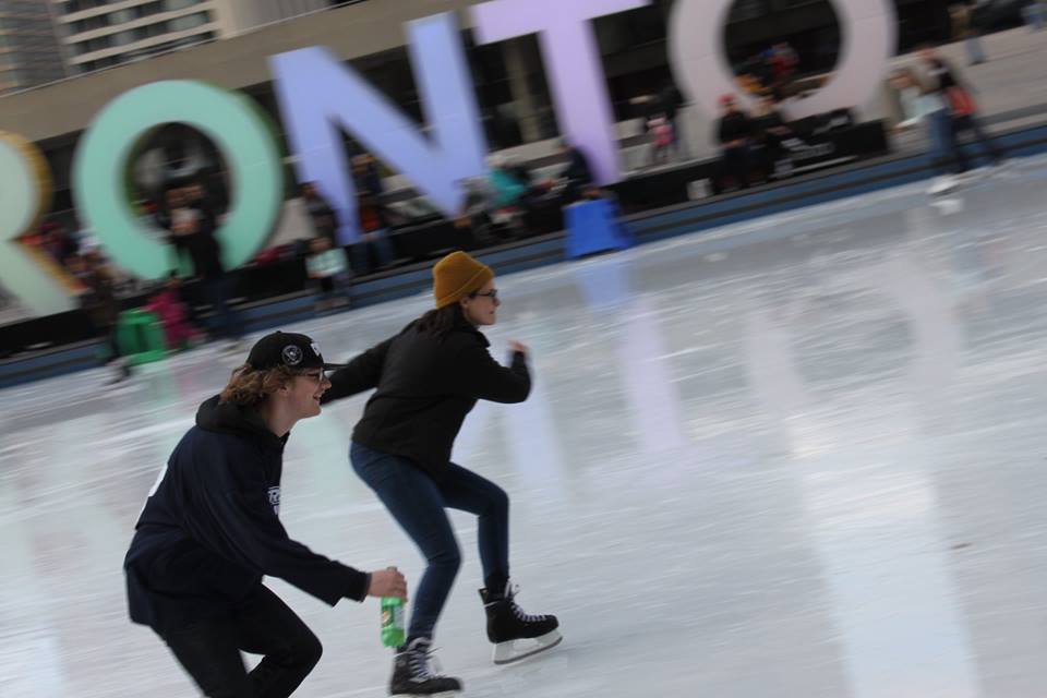 YMCA Academy teacher and student at the 2015 skating trip at Nathan Phillips Square