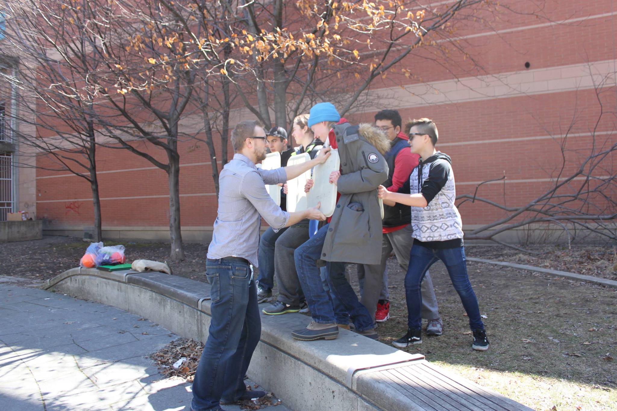 YMCA Academy students use a Roman shield formation.