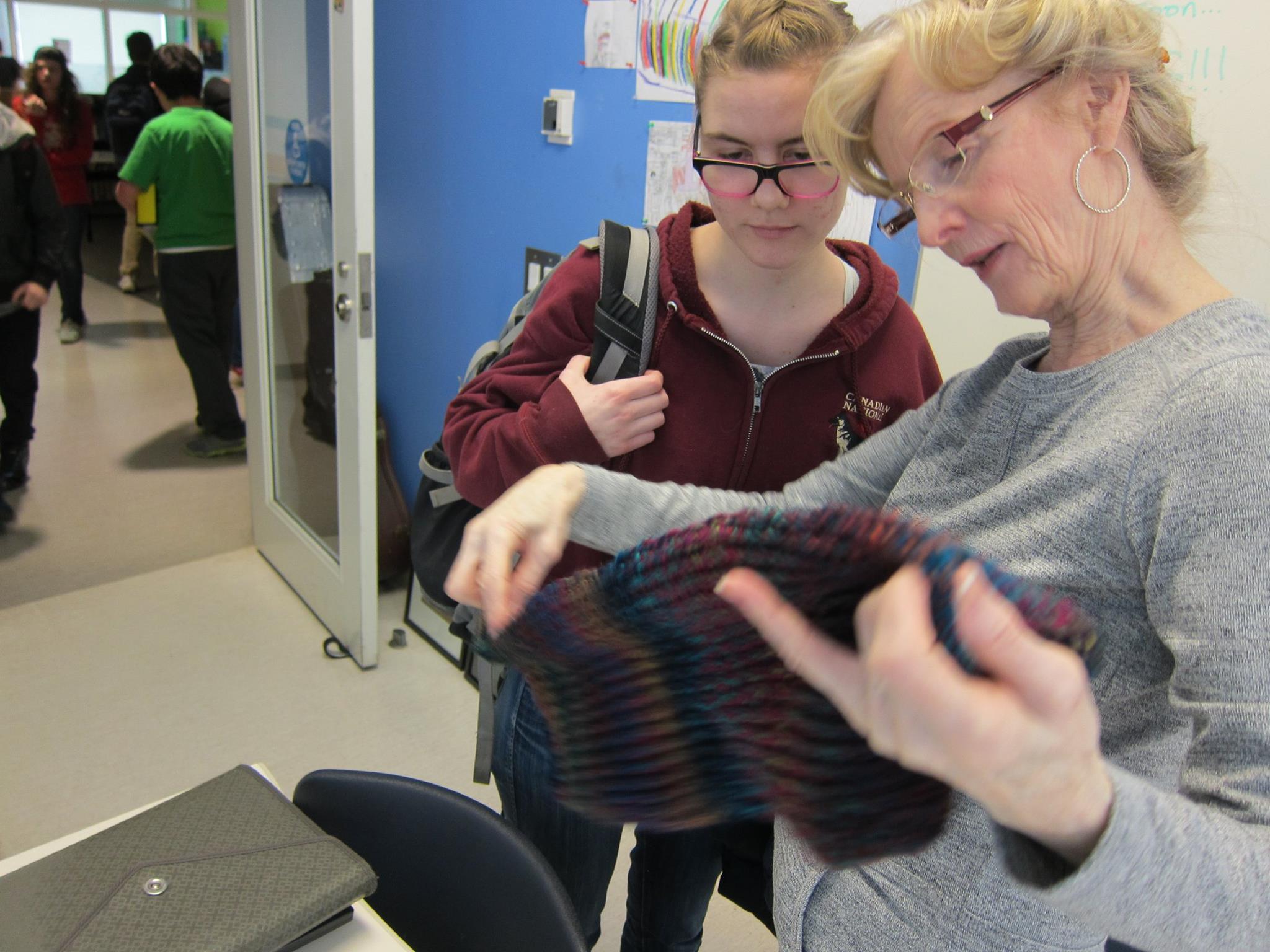 YMCA Academy students knit with a volunteer.