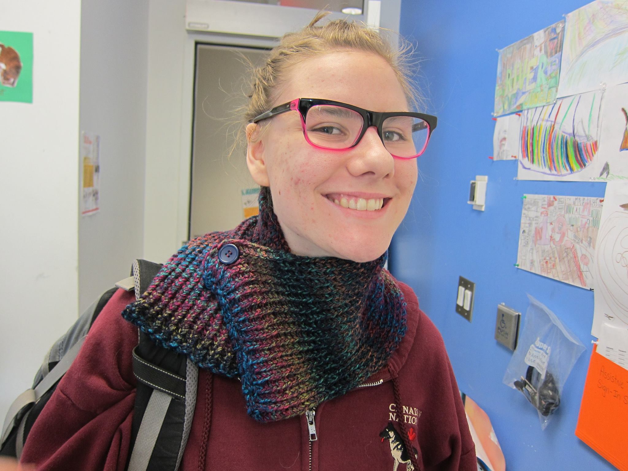 YMCA Academy students knit with a volunteer.