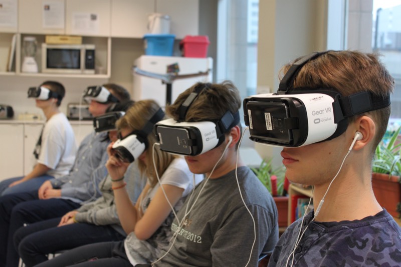 YMCA Academy students participate in a Virtual Reality experience named Clouds Over Sidra (2015, directed by Gabo Arora and Chris Milk)