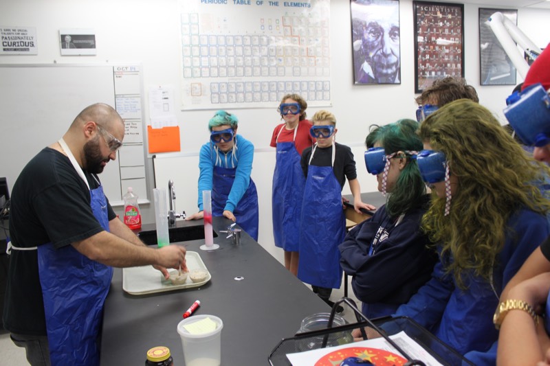 YMCA Academy students participate in the "Elephant Toothpaste" lab.