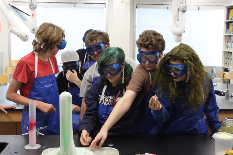 YMCA Academy students participate in the "Elephant Toothpaste" lab.