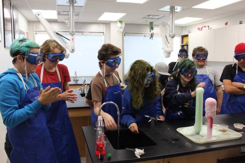 YMCA Academy students participate in the "Elephant Toothpaste" lab.