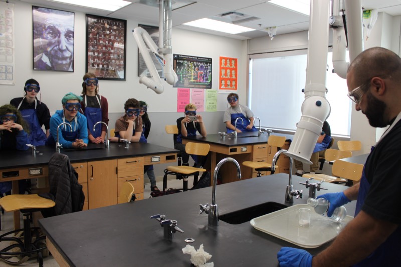 YMCA Academy students participate in the "Elephant Toothpaste" lab.