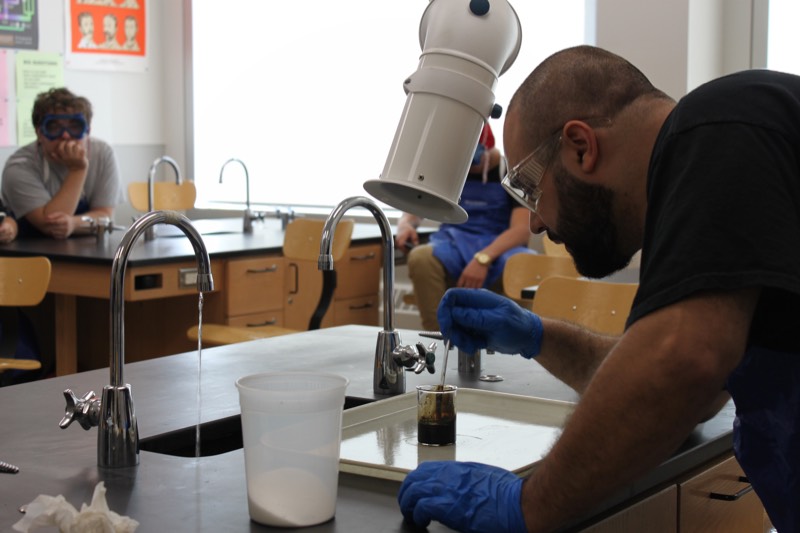 YMCA Academy students participate in the "Elephant Toothpaste" lab.