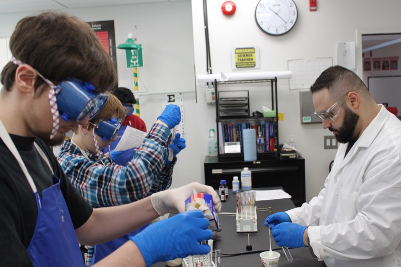 Students test various food items for protein, lipid and carbohydrate content.