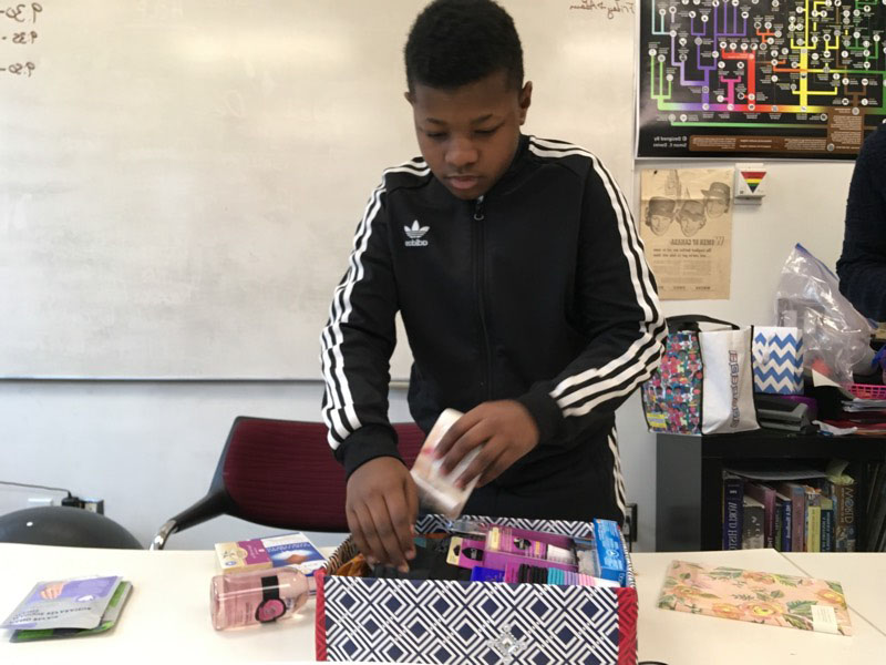 YMCA Academy students prepare gift-filled shoeboxes to support woman impacted by homelessness