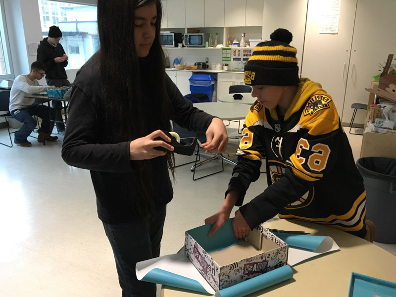 YMCA Academy students prepare gift-filled shoeboxes to support woman impacted by homelessness