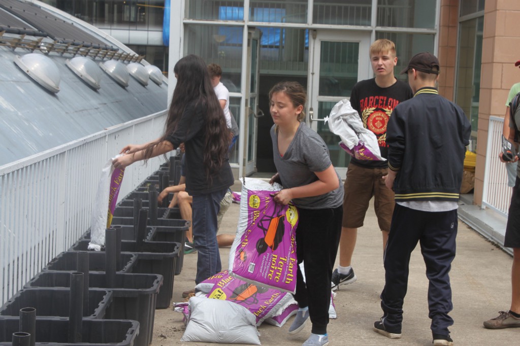 Academy students prepare the community garden with soil