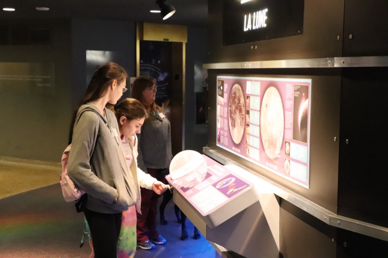 Students examine astronomy exhibits at the Ontario Science Centre