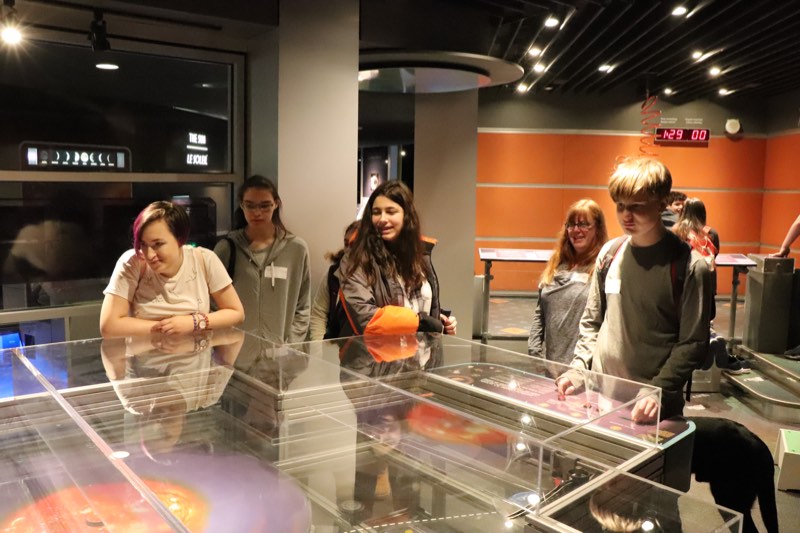 Students examine astronomy exhibits at the Ontario Science Centre