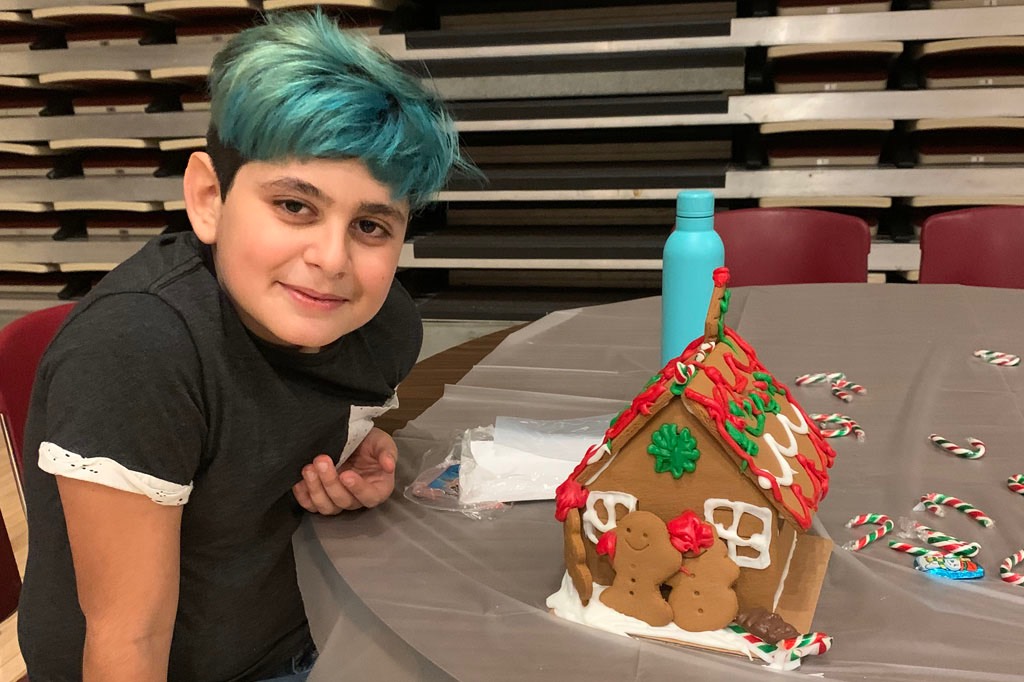 A student with a Gingerbread house during a school dance