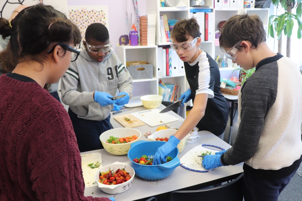 YMCA Academy middle school students create their famous batch of Hot and Fiery Hot Sauce