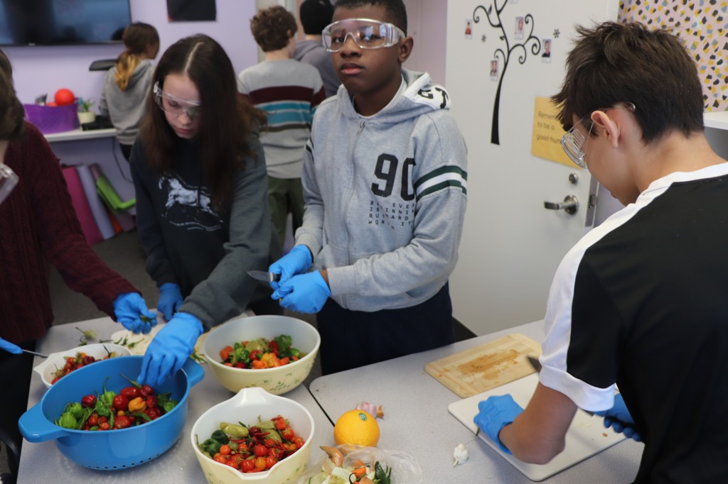 YMCA Academy middle school students create their famous batch of Hot and Fiery Hot Sauce