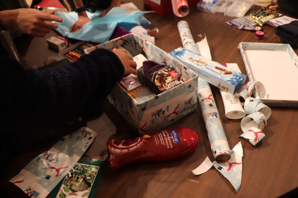 Students pack boxes for our second annual Shoebox Project initiative.