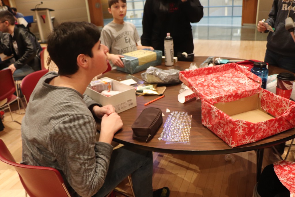 Students pack boxes for our second annual Shoebox Project initiative.