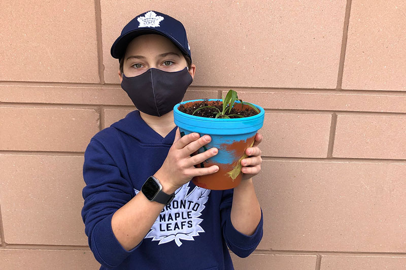 YMCA Academy Middle School students painting pots and planting their own plant