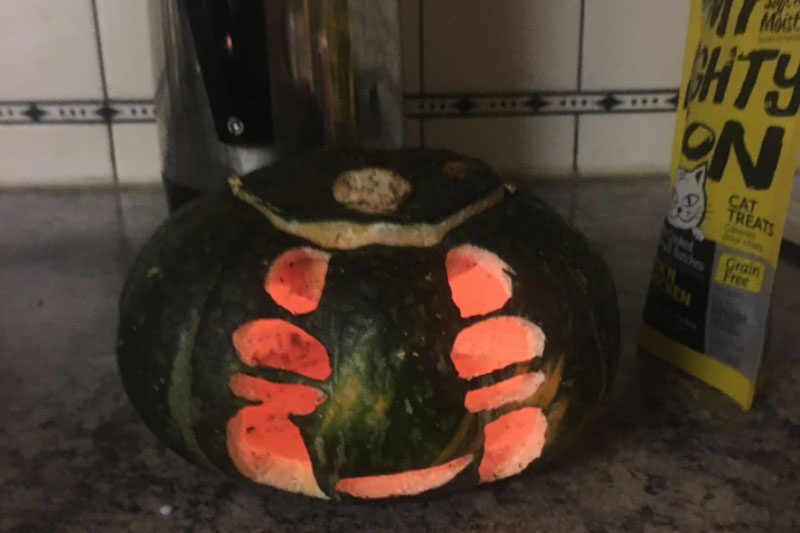 YMCA Academy students carve pumpkins for Halloween