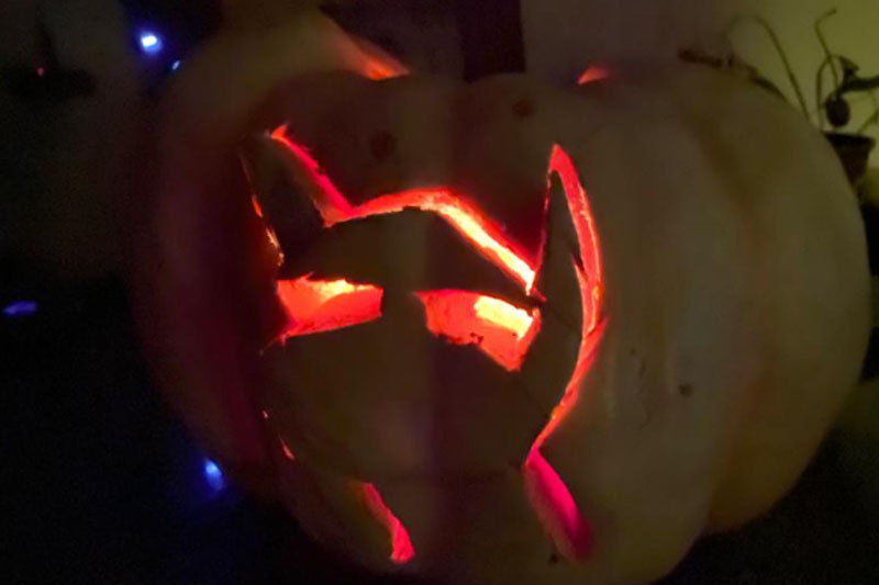 YMCA Academy students carve pumpkins for Halloween