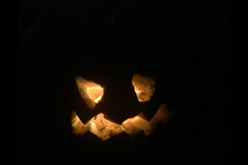 YMCA Academy students carve pumpkins for Halloween