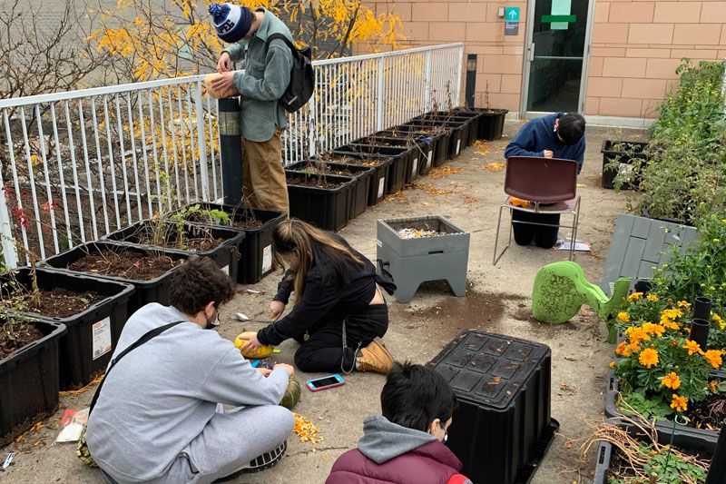 YMCA Academy students carve pumpkins for Halloween