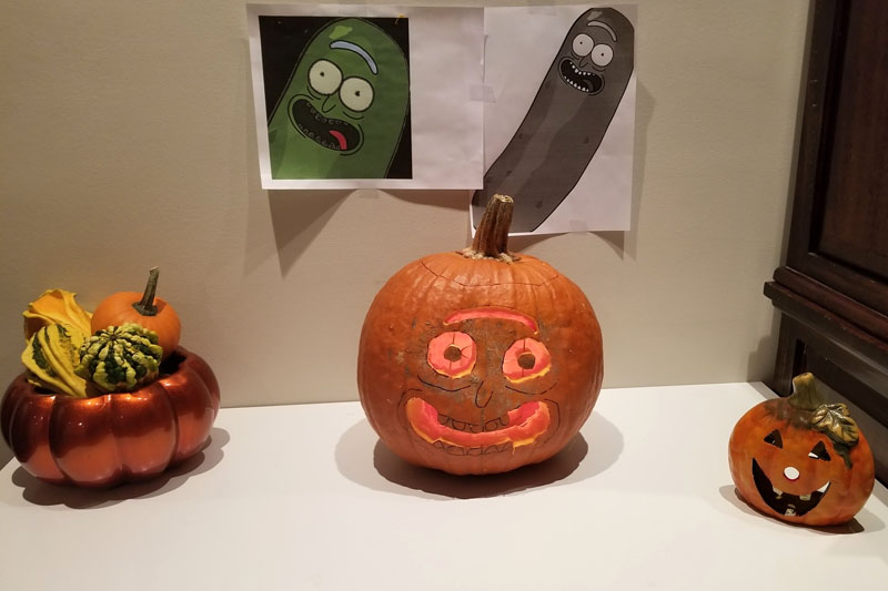 YMCA Academy students carve pumpkins for Halloween