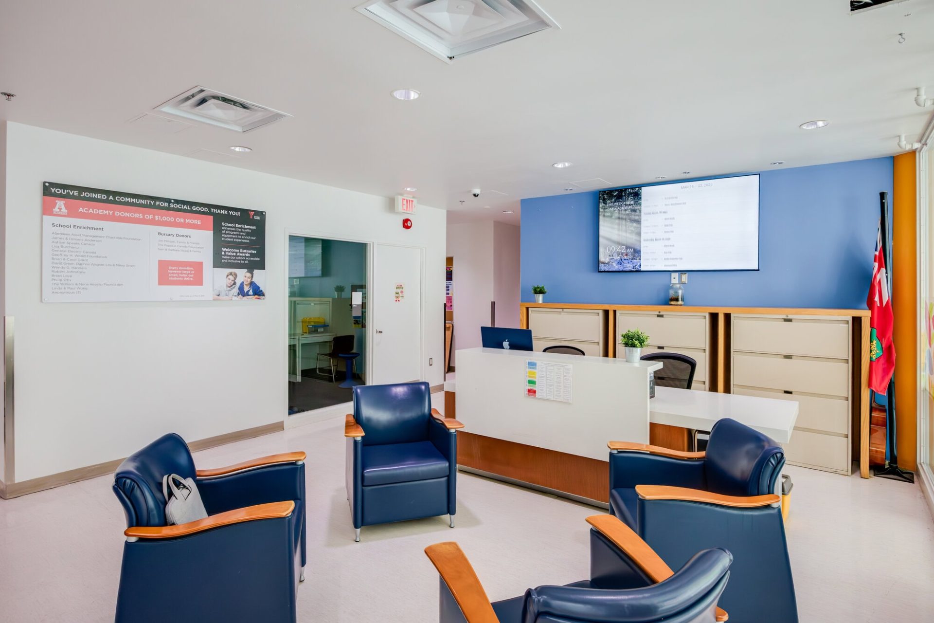 YMCA Academy reception area with seating and informational displays.