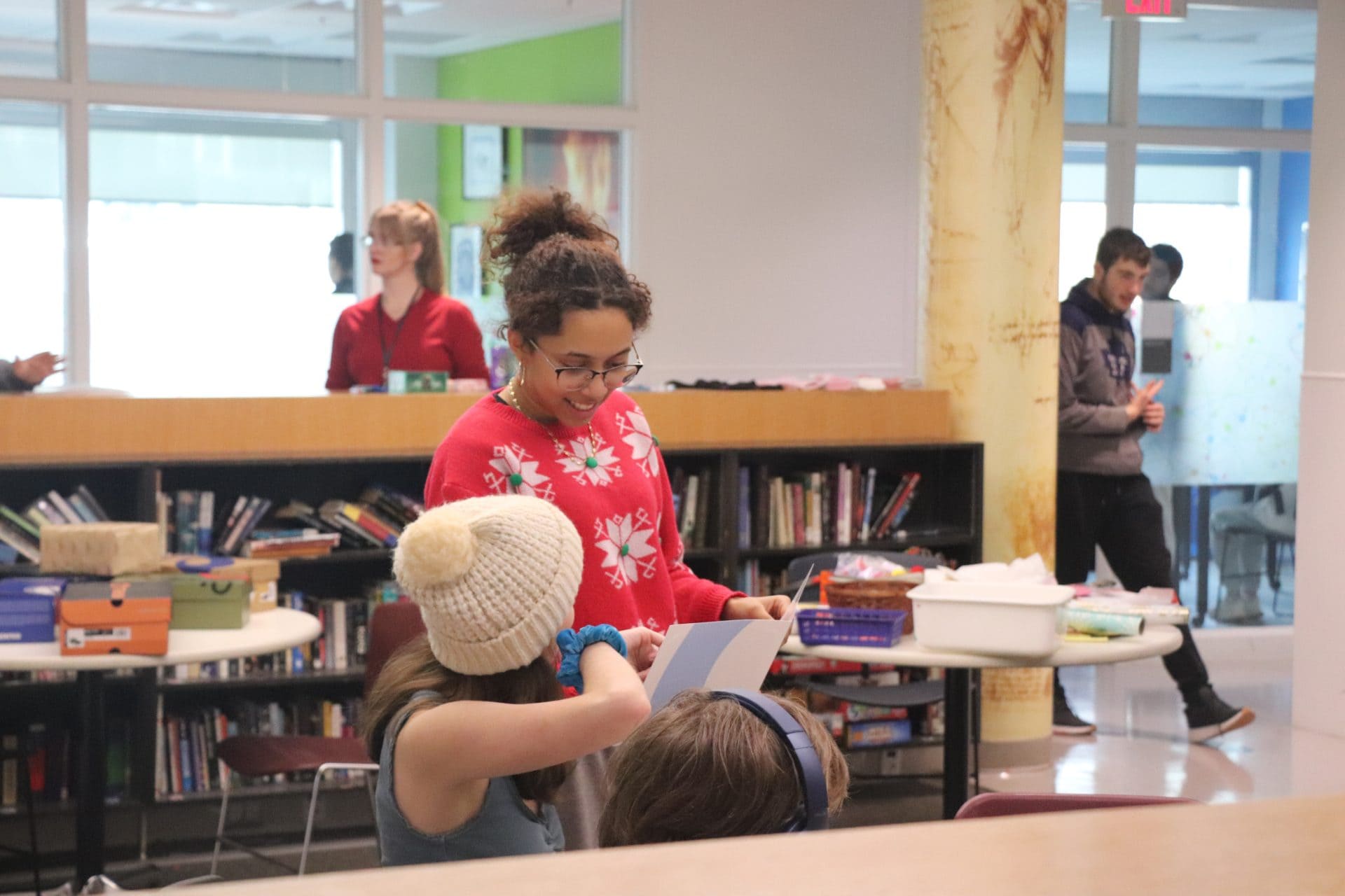 Young girl and teacher engaging in educational activity at YMCA Academy.
