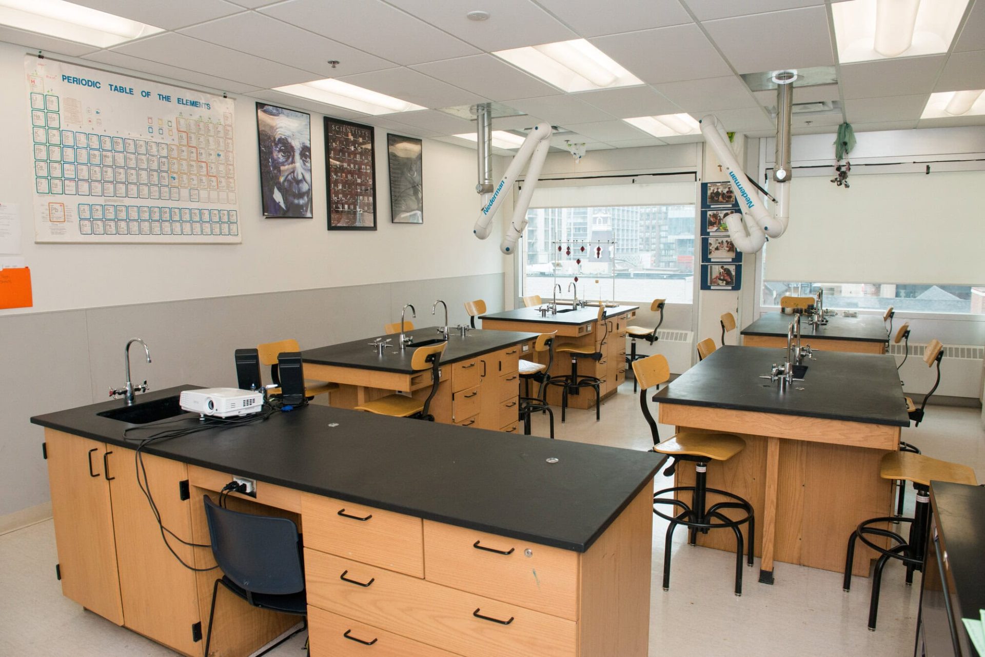 Modern science laboratory at YMCA Academy with workstations and equipment.