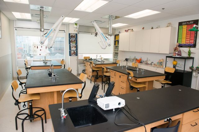 Modern science laboratory at YMCA Academy with workbenches and equipment.