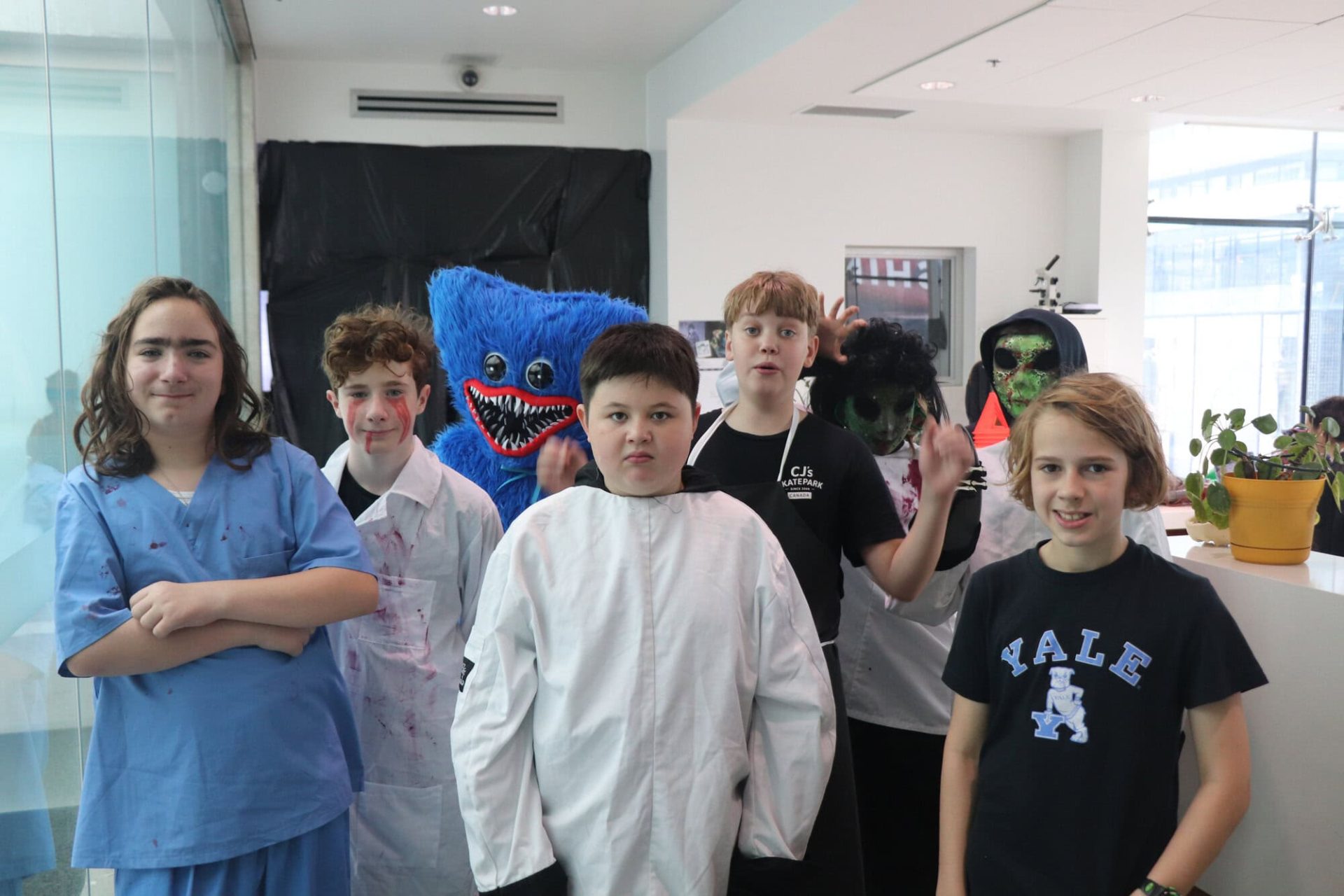 Group of children in costumes at YMCA Academy event.