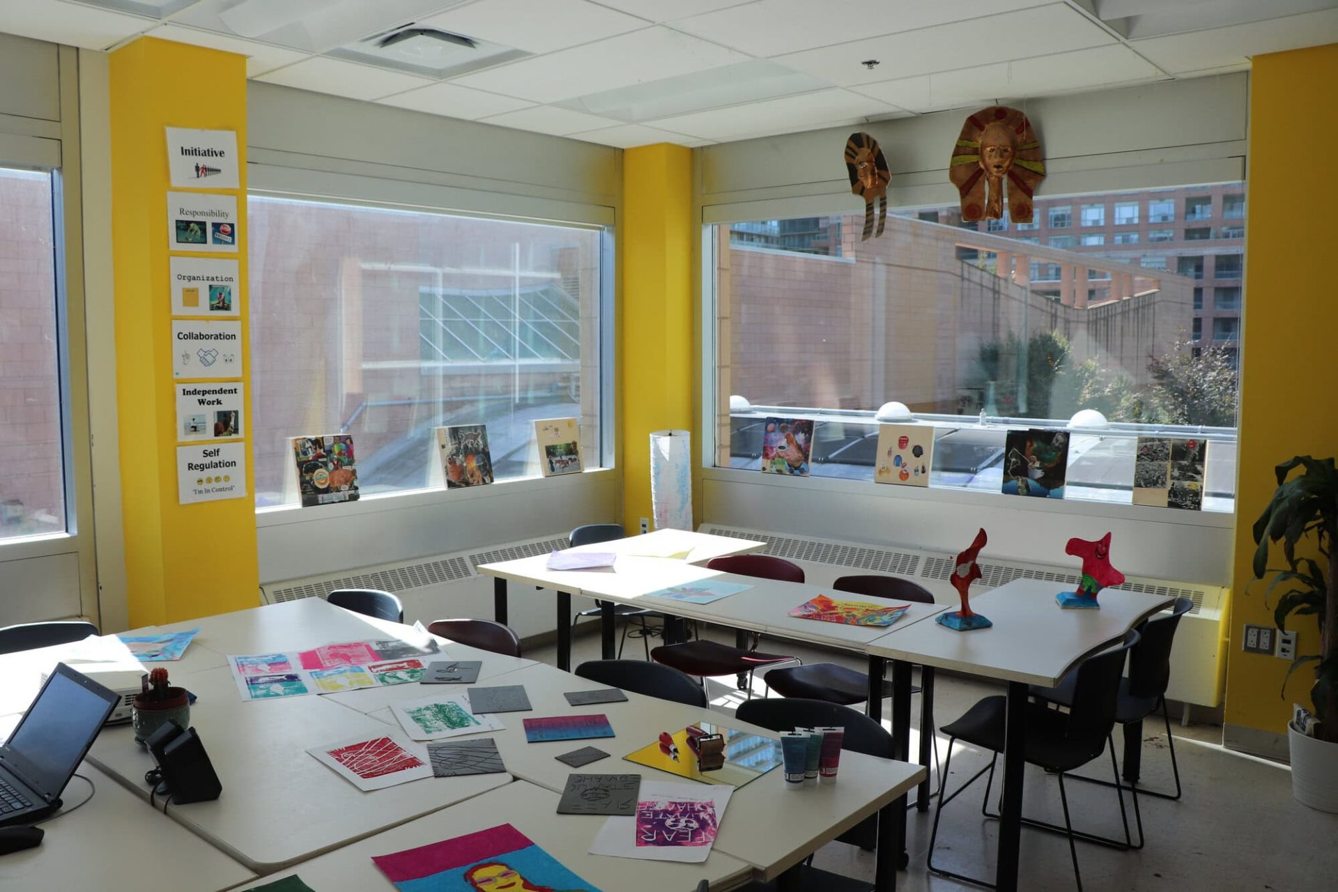Bright classroom with tables, chairs, and colorful decorations for special education students.