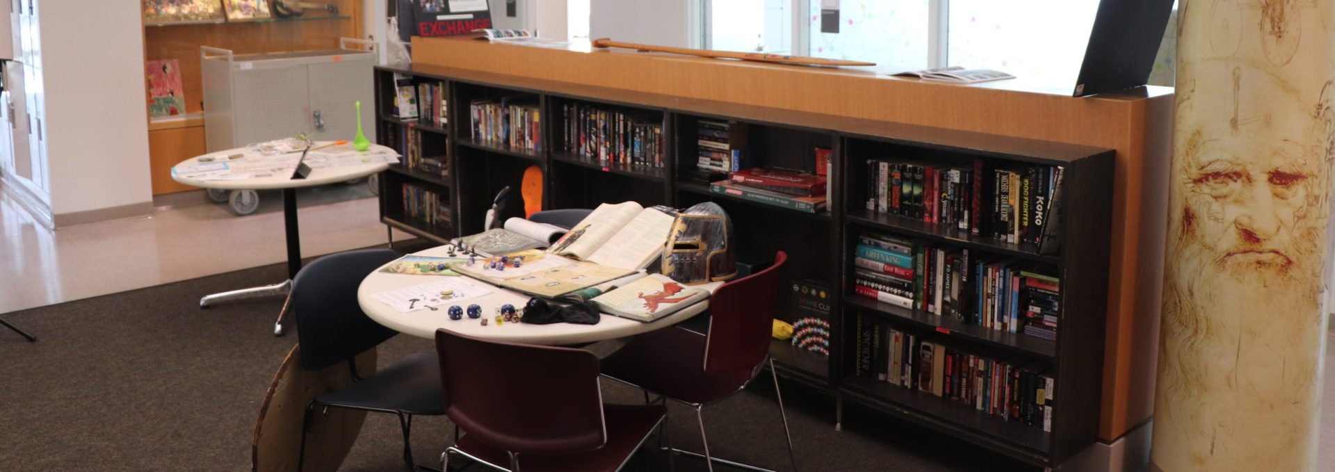 Study area at YMCA Academy with bookshelves and tables for students.