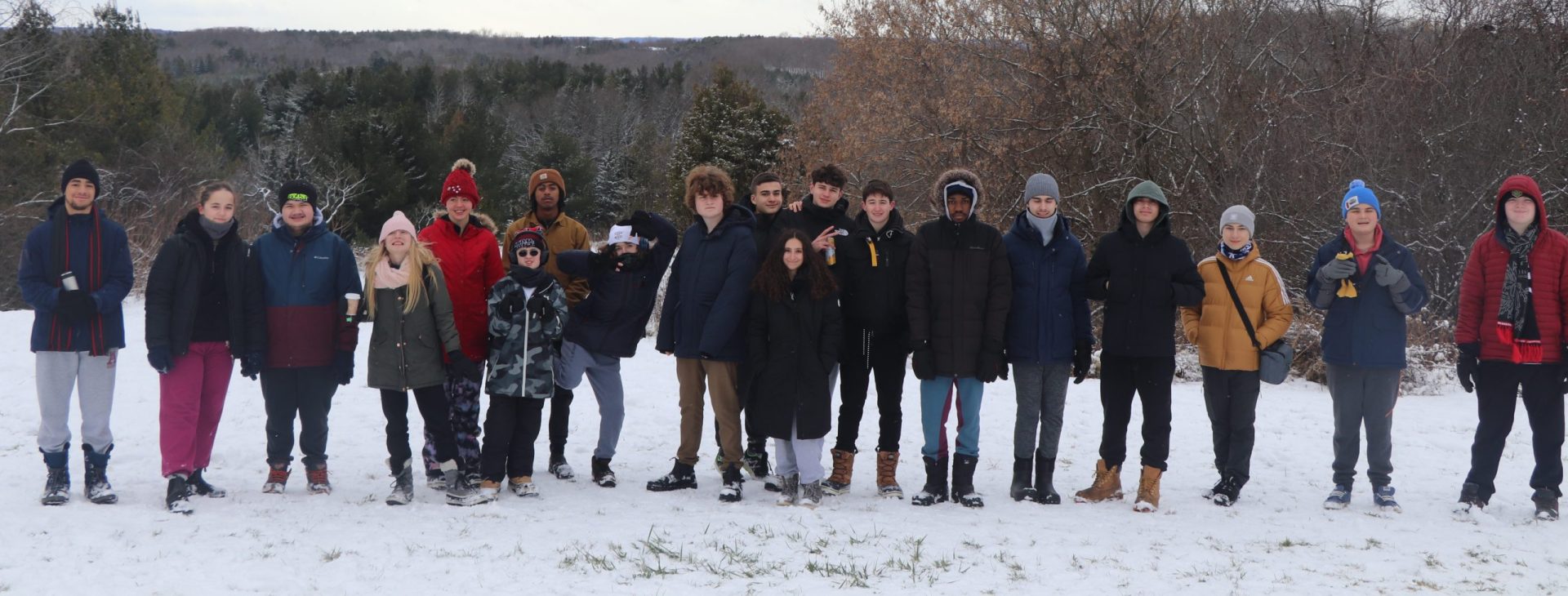 Group of students and teachers outdoors in winter at YMCA Academy.