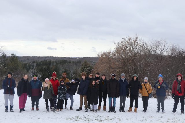 Group of children and teens outdoors in snow during winter at YMCA Academy.