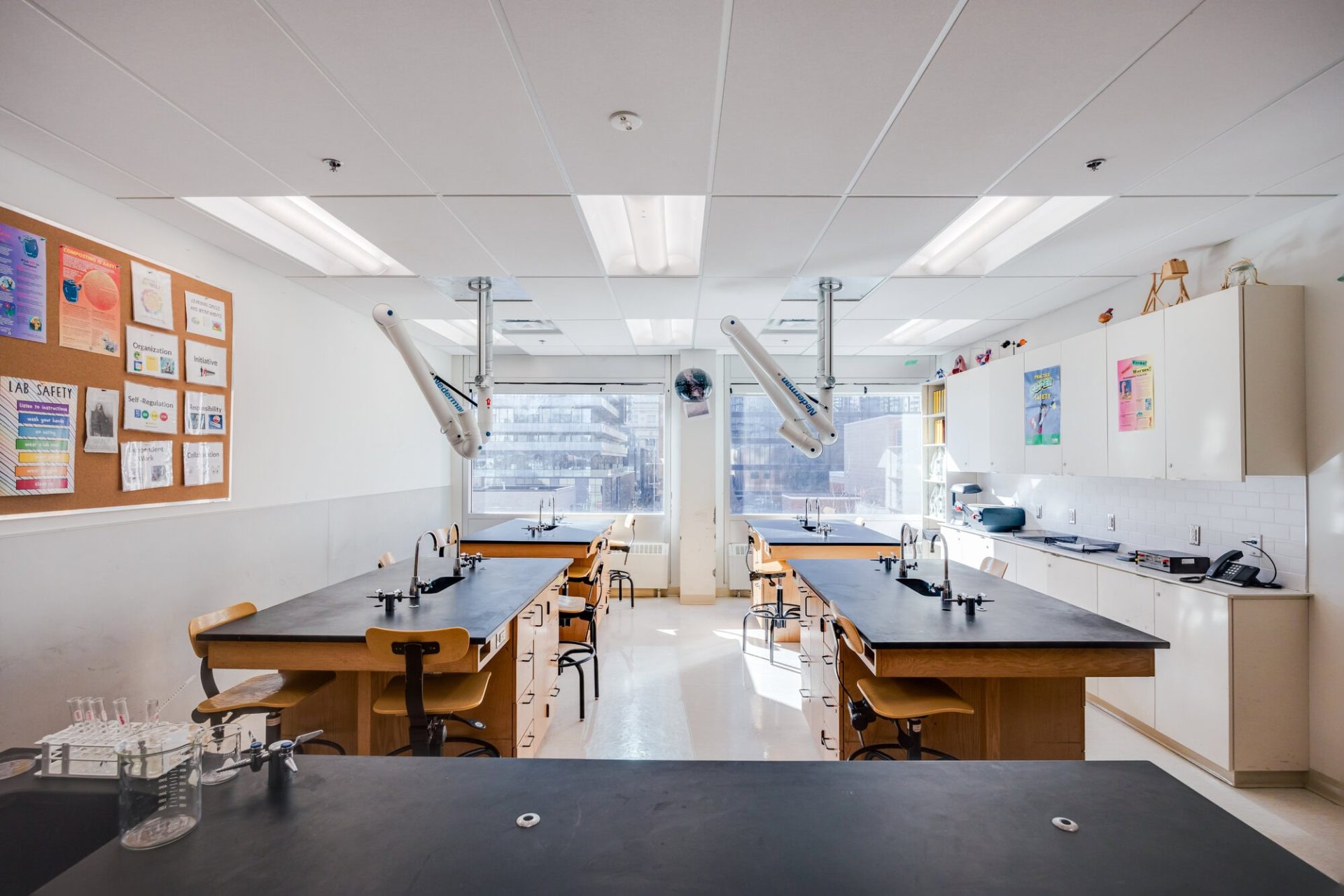 Bright classroom with desks, chairs, and learning materials at YMCA Academy.