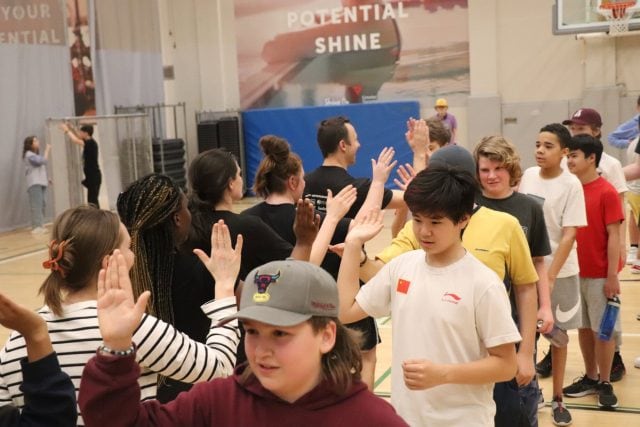 Students participating in a group activity at YMCA Academy for success stories.