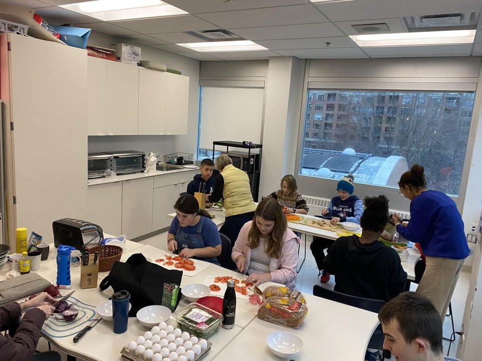 Children participating in a cooking class at YMCA Academy classroom.